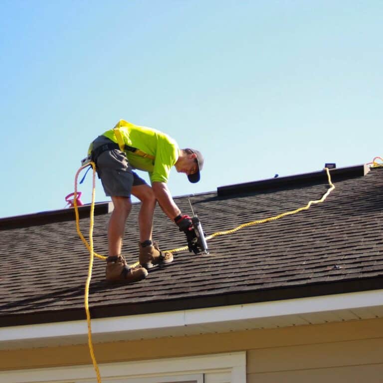 Roofing crew completing roofing work for a roofing contractor in Palm City, FL