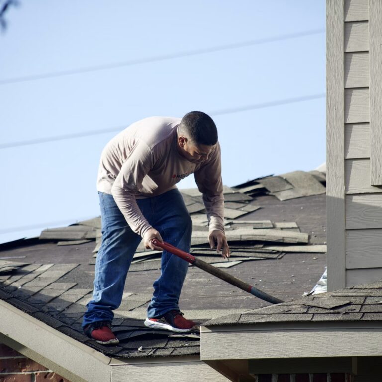 Roofing crew completing roofing work for a roofing contractor in Fort Pierce, FL